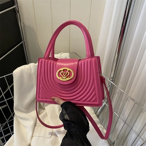 Retro rose pink quilted leather handbag with gold heart-shaped buckle and crossbody strap