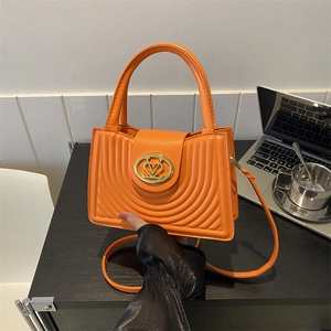 Orange vintage PU leather handbag with heart logo and curved stitching details