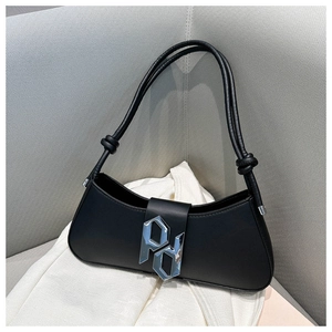 Close-up of the silver PD metal buckle on a black leather minimalist baguette bag