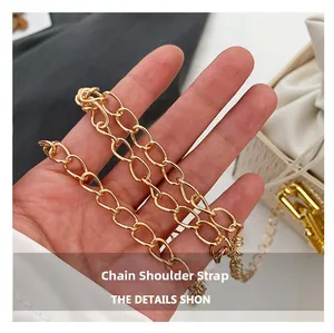 Detail shot of the golden metal chain strap with polished finish for bucket bags