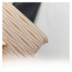 Close-up of premium plaid texture and gold-tone metal hardware on square bucket bag