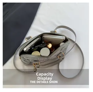 Internal capacity display of a grey vintage shell bag with floral prints and crossbody strap