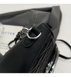 Detail shot of silver metal ring hardware on premium quilted black leather crossbody bag