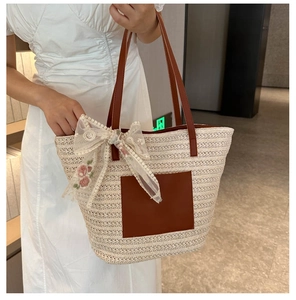 Straw tote bag with large white lace bow and delicate pink rose embroidery details