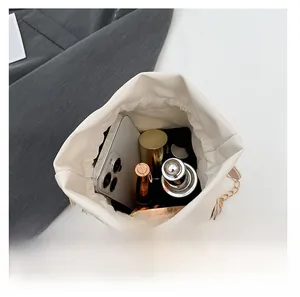 Interior view of white bucket bag showing large capacity for phone and cosmetics