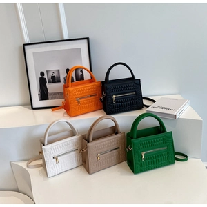 Minimalist faux crocodile leather handbags in five vibrant colors displayed on stands