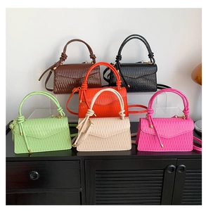 Minimalist square crossbody bags with pleated texture and knot handles in six vibrant colors