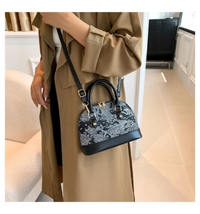 Classic shell bag with black and white floral embroidery and adjustable leather strap