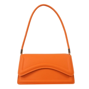 Bright orange underarm bag with wave-shaped flap design and gold hardware detail