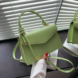 Chic light green crossbody bag with wavy texture and gold metal accents for women