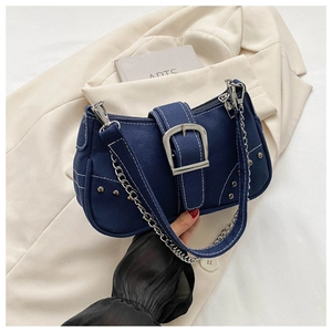 Detail of dark blue denim canvas bag featuring white contrast stitching and silver buckle