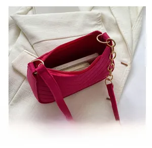 Internal view of rose pink felt crossbody bag showing phone and wallet capacity