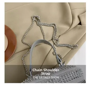 Detail shot of the shimmering rhinestone handbag with elegant silver chain strap