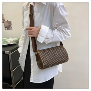 Retro cylinder crossbody bag with vintage monogram pattern and adjustable wide strap
