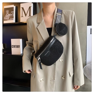 Detail of black rhinestone saddle bag and round coin purse with woven geometric strap