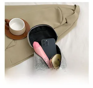 Interior view showing the capacity of this rhinestone bag with makeup and phone