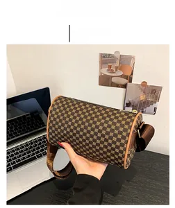Detailed view of brown retro cylinder bag with geometric print and fabric strap