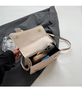 Detail of light beige PU leather bag interior with magnetic snap and ample storage space