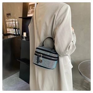 Fashionable gradient rhinestone shoulder bag with silver chain worn by a woman