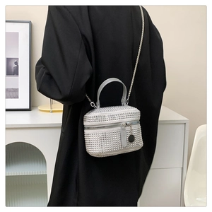 Close-up of sparkling silver rhinestone handbag with chain strap and top handle