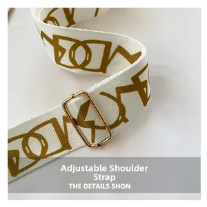 Detail of adjustable mustard yellow geometric strap with premium gold metal buckle