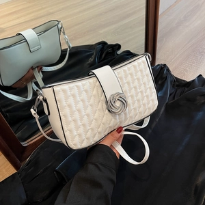 White quilted shoulder bag with silver metal twist clasp and adjustable crossbody strap