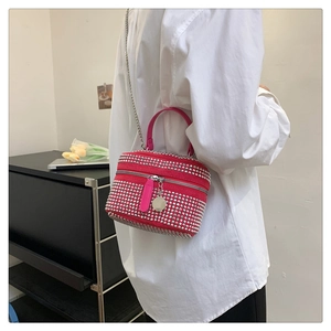 Detailed close-up of a pink mini crossbody bag featuring sparkling silver rhinestones