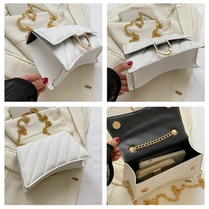 Macro shot of white quilted crossbody bag showing interior capacity and golden horseshoe lock