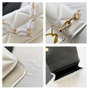 Detail of white quilted handbag with gold hardware, acrylic chain and wide strap