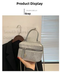 Detailed view of a silver rhinestone mini handbag with chain strap and top handle