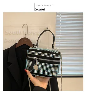 Close-up of multicolor rhinestone box bag with silver chain strap and metal zipper detail