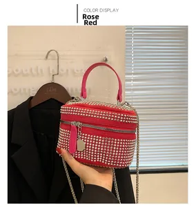 Detail of rose red bag with silver rhinestones, top handle and metal chain strap