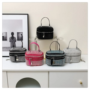 Close-up of luxury rhinestone mini handbags in five vibrant colors with metal chain straps