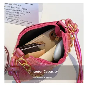 Internal view of pink snake pattern handbag showing space for cosmetics and phone