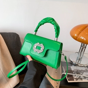 Green leather tote bag with crystal buckle and scrunchie handle for crossbody wear