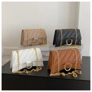 Detail of four quilted chain crossbody bags with unique curved base and gold U-shaped buckles