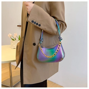 Detailed macro of gradient snake-pattern leather bag with chunky gold chain decoration