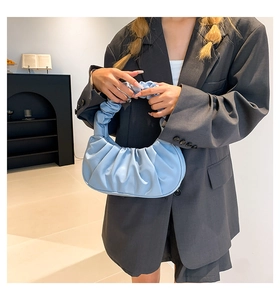 Detailed view of light blue ruched cloud bag with pleated half-moon design and soft handle