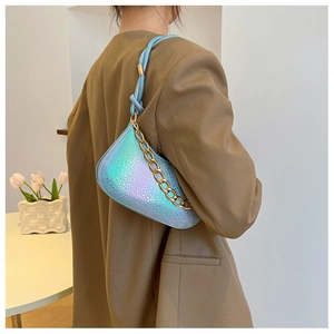 Side view of laser blue snake-textured underarm bag with gold metal chain on a model