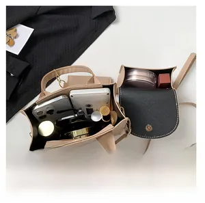 Top view of beige crossbody bag interior showing storage space for phone and makeup