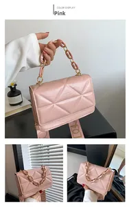 Detailed view of pink quilted handbag with gold chain handle and wide strap