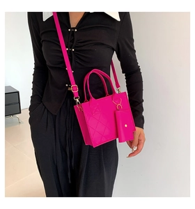 Close-up of bright pink quilted crossbody set with matching mini pouch and gold hardware