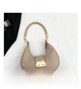 Detail view of the light brown crescent underarm bag with smooth matte leather finish