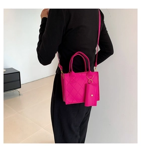 Detail of fuchsia quilted handbag set with mini coin purse and adjustable shoulder strap