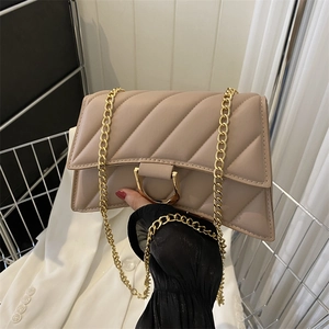 Quilted beige hourglass crossbody bag with gold D-buckle and metal chain strap