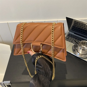 Chic caramel brown hourglass chain bag with diamond quilting and gold D-clasp detail