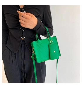 Detail of bright green quilted crossbody bag with matching coin purse and gold hardware