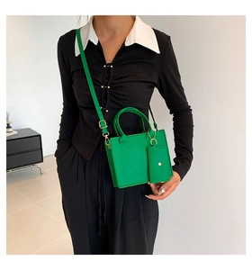 Detail of green quilted crossbody bag with matching coin purse and slim shoulder strap
