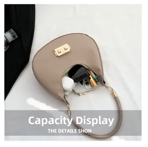Detail view of khaki half-moon bag interior holding phone, lipstick and sunglasses