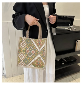 Detailed close-up of a large ethnic tote bag with embroidered geometric patterns
